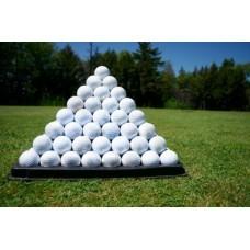 Golf Balls stacked in a pyramid